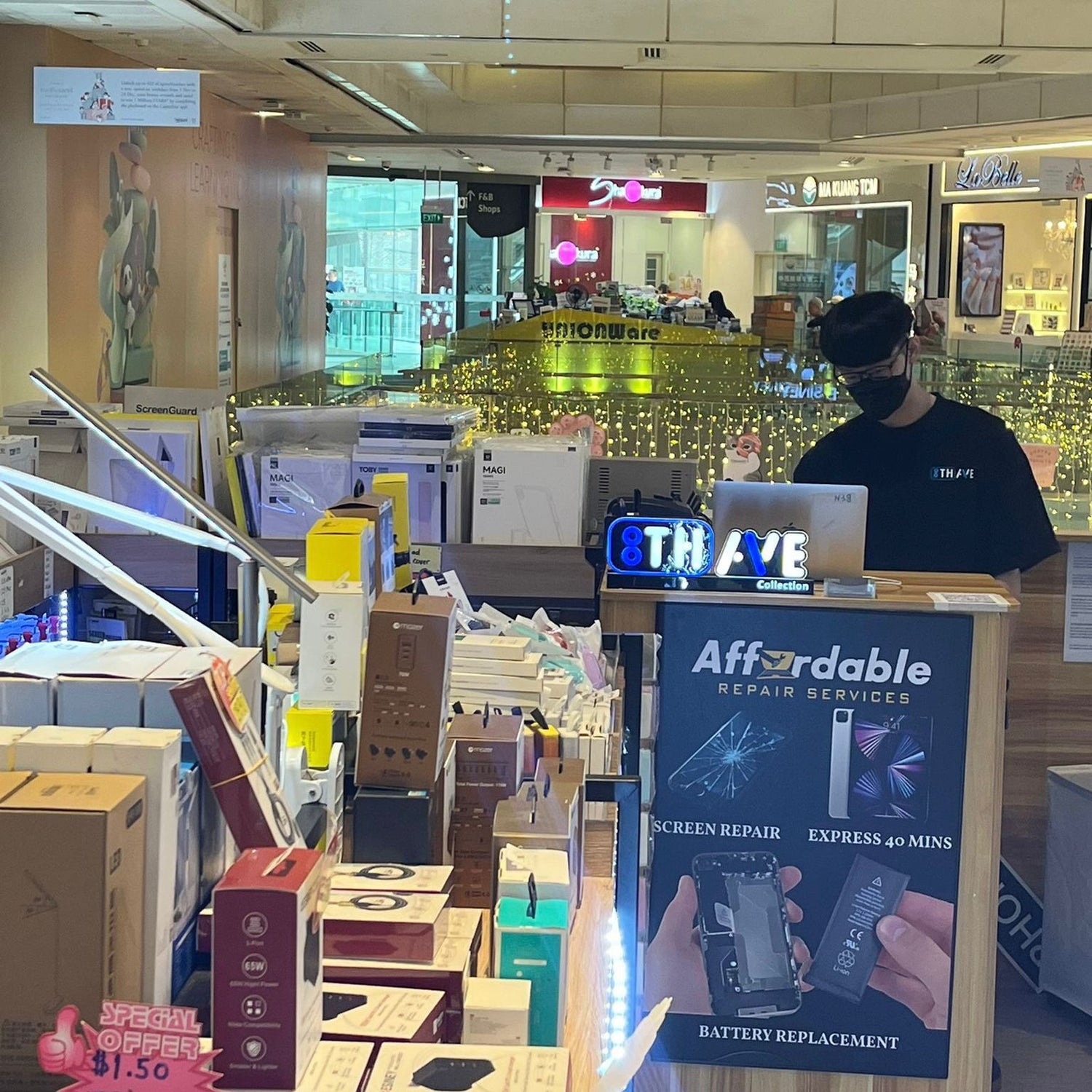 Store interior with a customer service desk and "8th ave" signs.